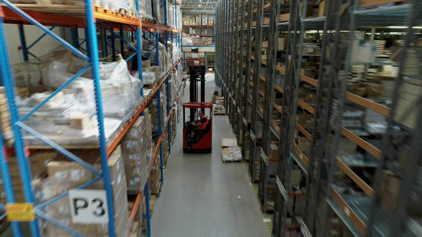 istock Warehouse logistic center. Worker driving on a forklift. Aerial view 1150944655