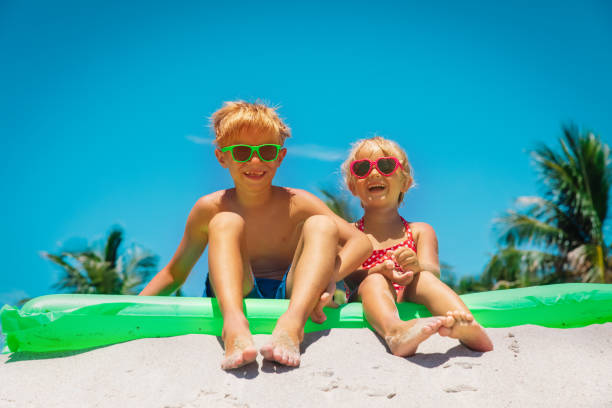 istock happy boy and girl have fun on beach 1150944728