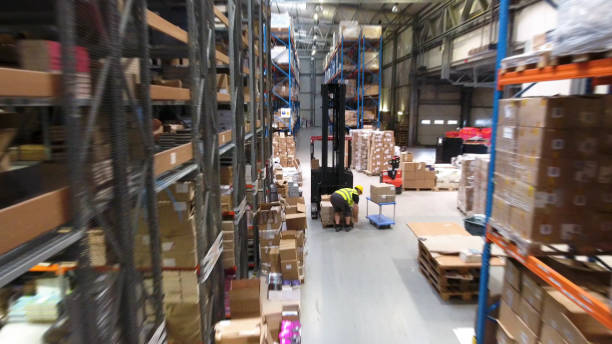 istock Warehouse logistic center. Worker driving on a forklift. Aerial view 1150944787