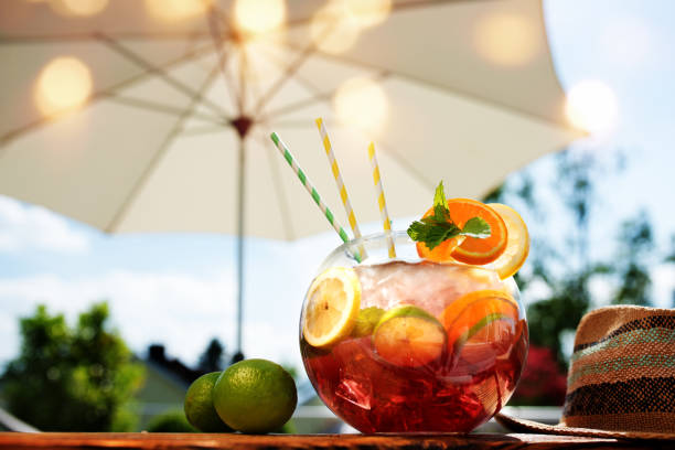 Sangria cocktail in the summer Red sangria cocktail on a summer terrace with a parasol sangria stock pictures, royalty-free photos & images