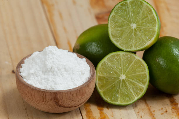 istock baking soda - sodium bicarbonate and lemon, on wooden background 1150952127