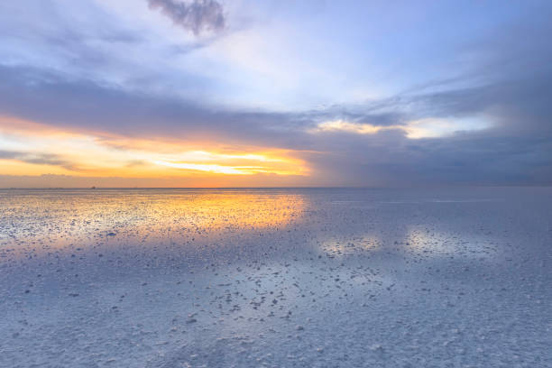 istock Abstract photo in Salar de Uyuni without a main subject with sunset clouds and their reflection. In the foreground are salt outgrowths in shallow water. Bolivia, South America 1150953169