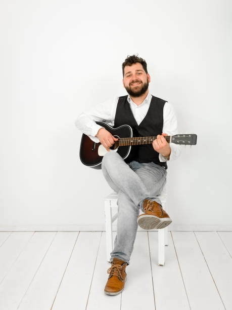 istock man with acoustic guitar on white background 1150953460
