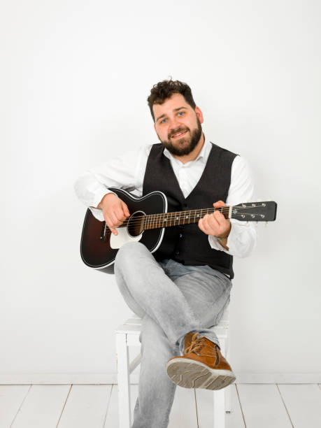 istock man with acoustic guitar on white background 1150953480