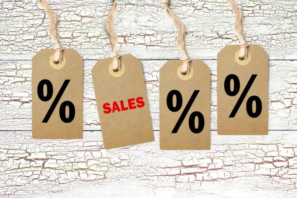 Hangtags with title "Sales" on wooden background