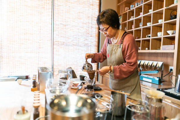 istock Chinese female coffee shop owner making coffee 1150954918