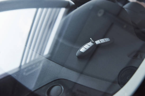istock Automobile keys lying on the front panel of the car that captured through the window 1150955181