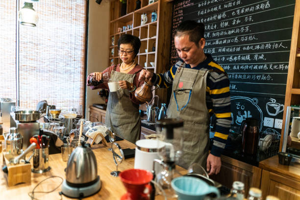 istock Married Chinese couple making pour-over coffee in their cafe 1150955863