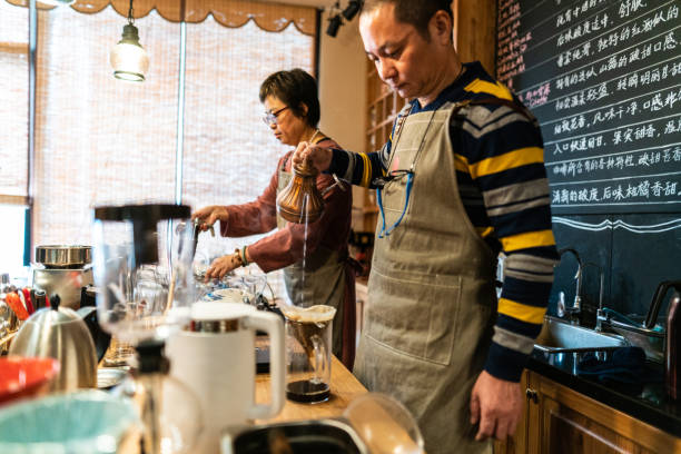 istock Married Chinese couple making pour-over coffee in their cafe 1150956445
