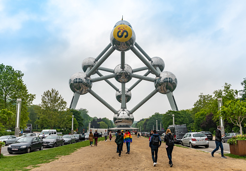 Brussels, Belgium - May 19 2019: People walk and take photos at the base of the Atomium building in Brussels.