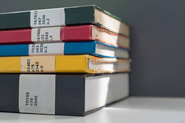istock Close up books stacked on the table at the university library in selective focus. 1150958616