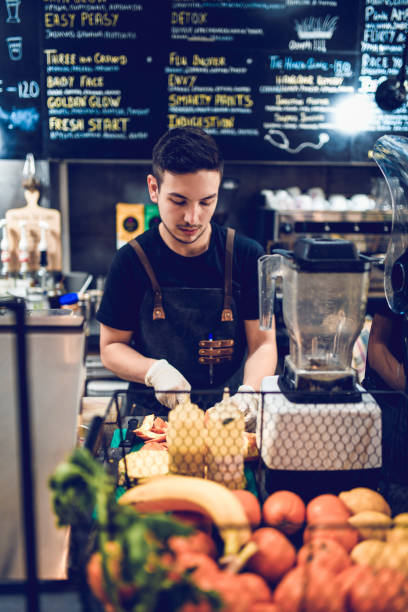 istock Male Barista Cutting Fruit For Smoothies 1150961483