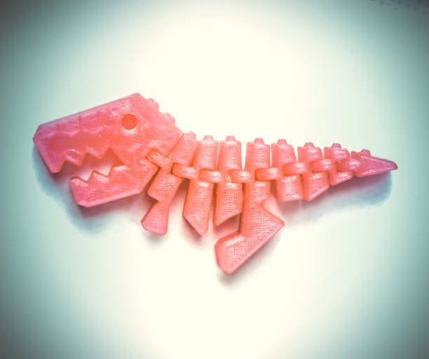 istock Bright light pink object in shape of dinosaur toy printed on 3d printer 1150962298