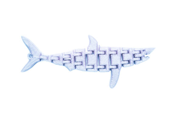 istock Bright light pink object in shape of fish toy printed on 3d printer 1150962304