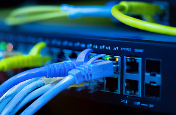 istock Lan swicth network yellow rj45 cable cool tone. 1150962648