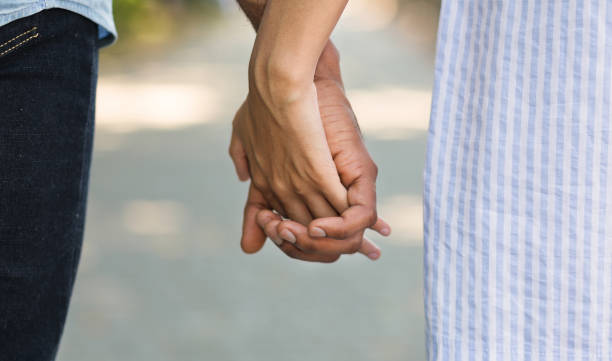 istock African-american couple holding hands while walking in park 1150964354