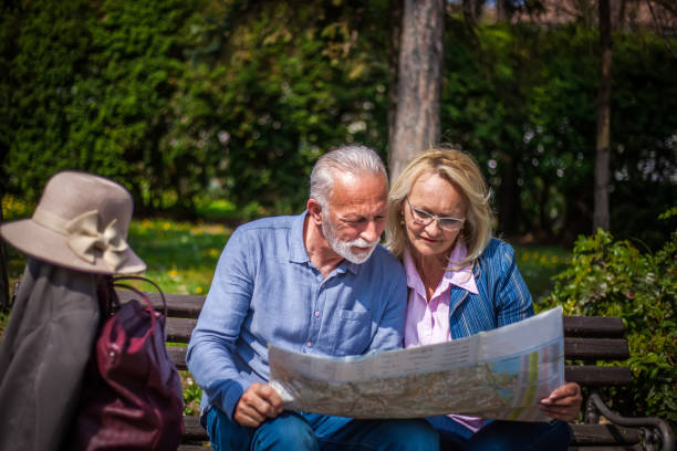 istock Senior tourists looking at a city map 1150965100