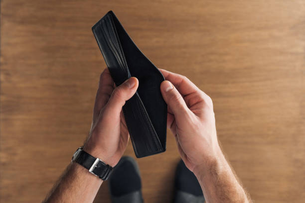 istock top view of man holding empty wallet on wooden background 1150971825