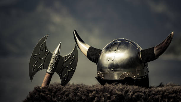Viking helmet on fjord shore, Norway Viking helmet with axe on fjord shore in Norway. Tourism and traveling concept axe photos stock pictures, royalty-free photos & images