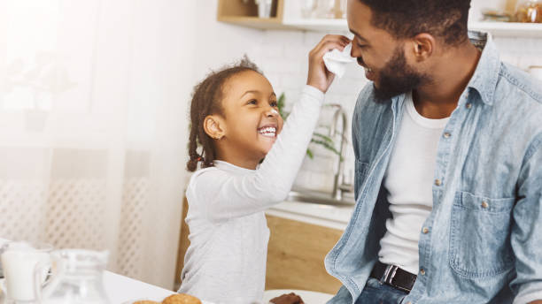 istock Happy afro man and his daughter having breakfast 1150972998