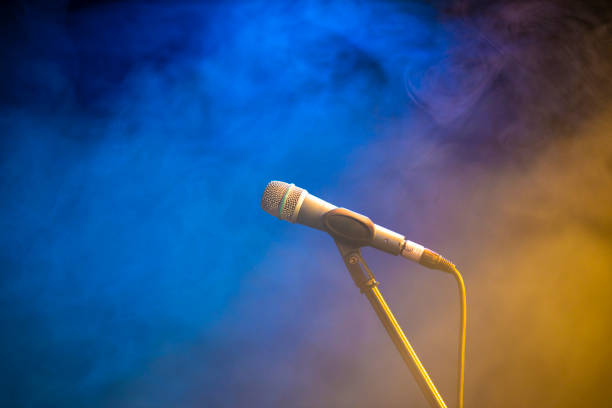 istock Microphone on empty stage in the fog 1150973087