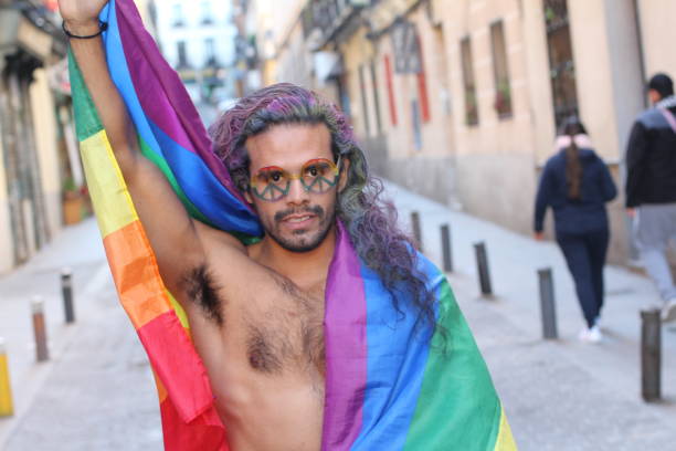 istock Muscular ethnic man with the rainbow flag 1150973346