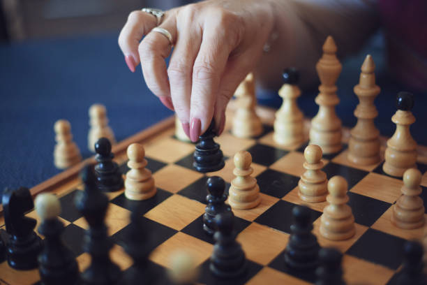 istock Grandson playing chess against his grandmother 1150973799