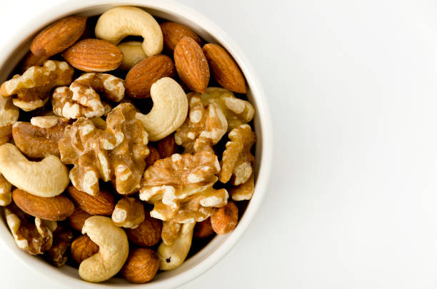 istock mix of nuts in a cocotte on a white background. 1150974744