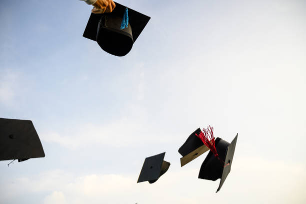 istock Throw a black hat of graduates in the sky. 1150974831