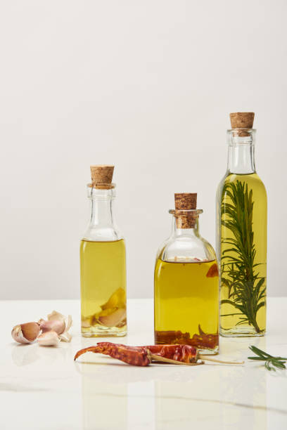 istock different bottles with oil flavored with various spices and rosemary on white surface 1150974845
