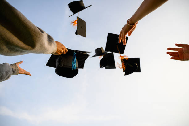 istock Throw a black hat of graduates in the sky. 1150974921