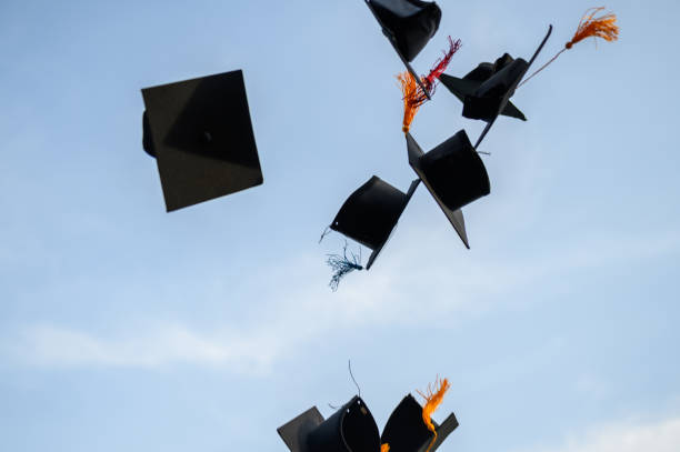 istock Throw a black hat of graduates in the sky. 1150974947