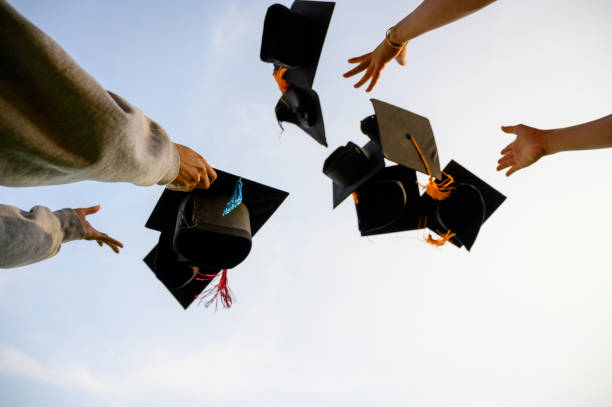 istock Throw a black hat of graduates in the sky. 1150975014