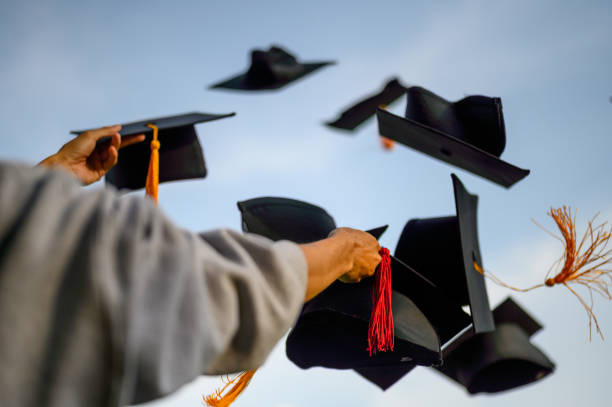 istock Throw a black hat of graduates in the sky. 1150975082