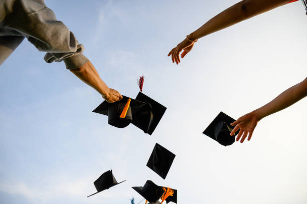 istock Throw a black hat of graduates in the sky. 1150975093