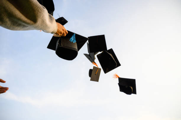 istock Throw a black hat of graduates in the sky. 1150975104