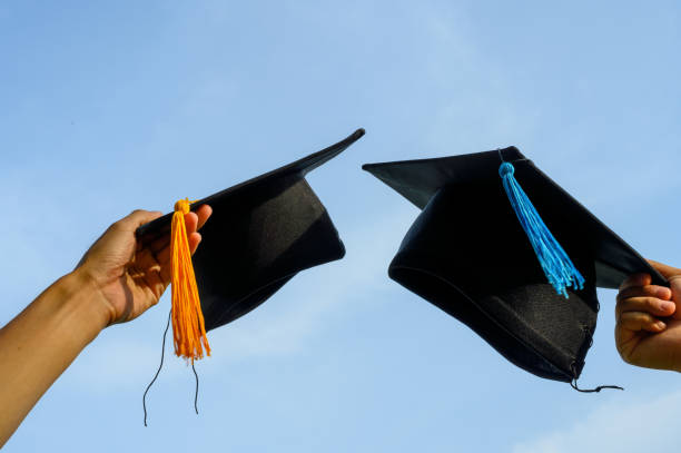 istock Throw a black hat of graduates in the sky. 1150975120