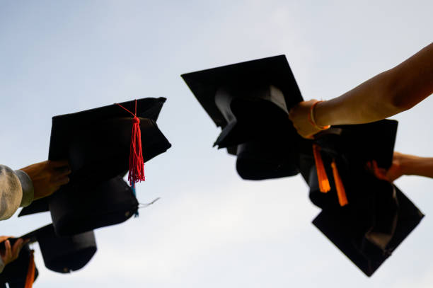 istock Throw a black hat of graduates in the sky. 1150975122