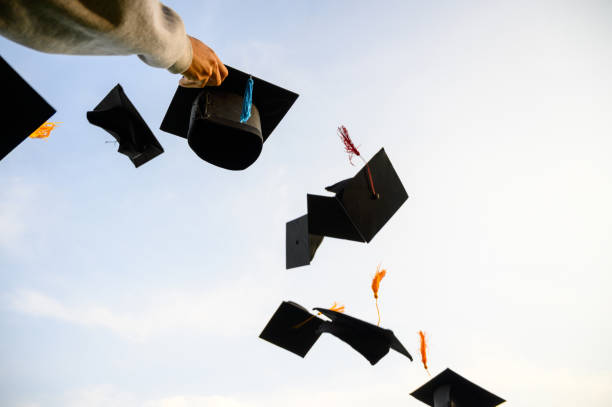 istock Throw a black hat of graduates in the sky. 1150975123