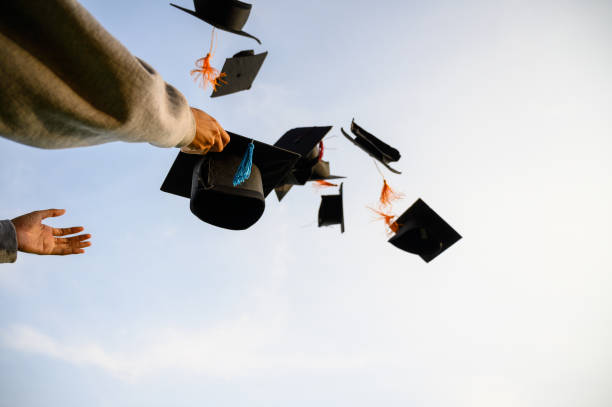 istock Throw a black hat of graduates in the sky. 1150975202