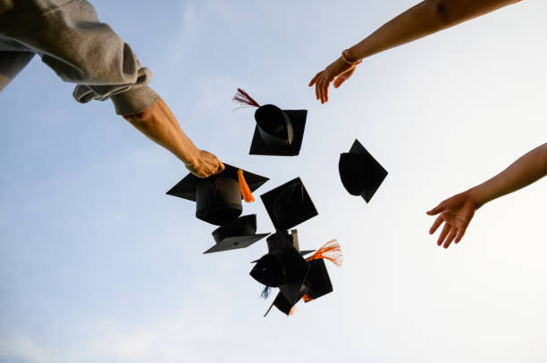 istock Throw a black hat of graduates in the sky. 1150975234