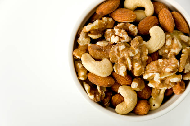 istock mix of nuts in a cocotte on a white background. 1150975798