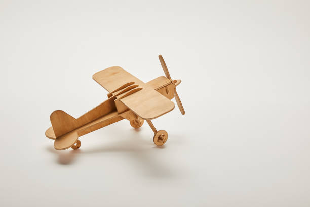 toy plane on grey background with copy space toy plane on grey background with copy space toy airplane stock pictures, royalty-free photos & images