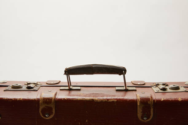 istock lather brown suitcase with copy space isolated on grey 1150975840