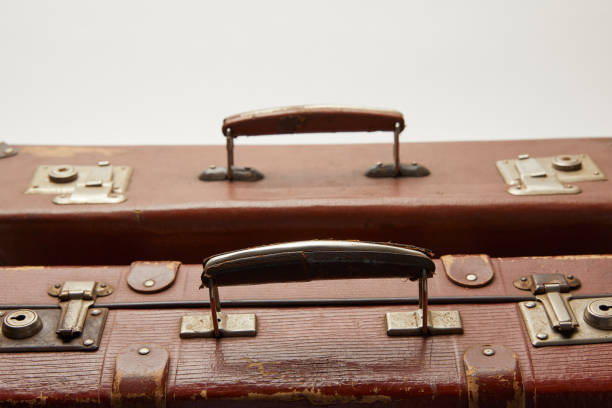 istock vintage brown suitcases isolated on grey 1150975846