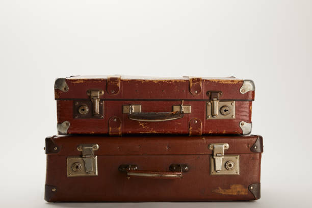 istock vintage brown suitcases on grey background with copy space 1150975867
