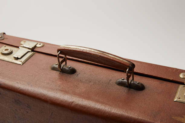 istock close up of vintage brown suitcase isolated on grey 1150975875