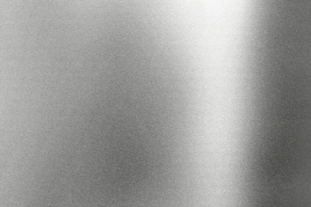 istock Light shining on rough gray metal wall, abstract texture background 1150976440