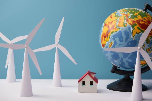 istock windmill and house models with globe on white table and blue background 1150978186