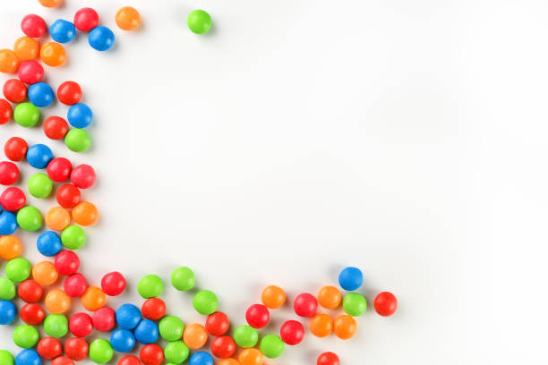 istock Frame of multi-colored candies close up. Rainbow colored dragee multicolored glaze on a white background 1150978311